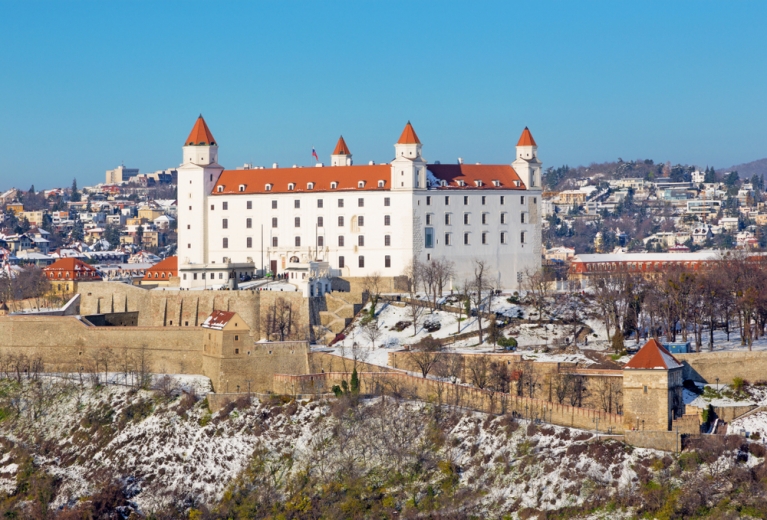 A white fortress in Bratislava, with a dusting of snow around it