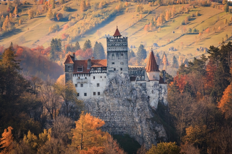 Bran Castle in Romania, surrounded by autumn trees