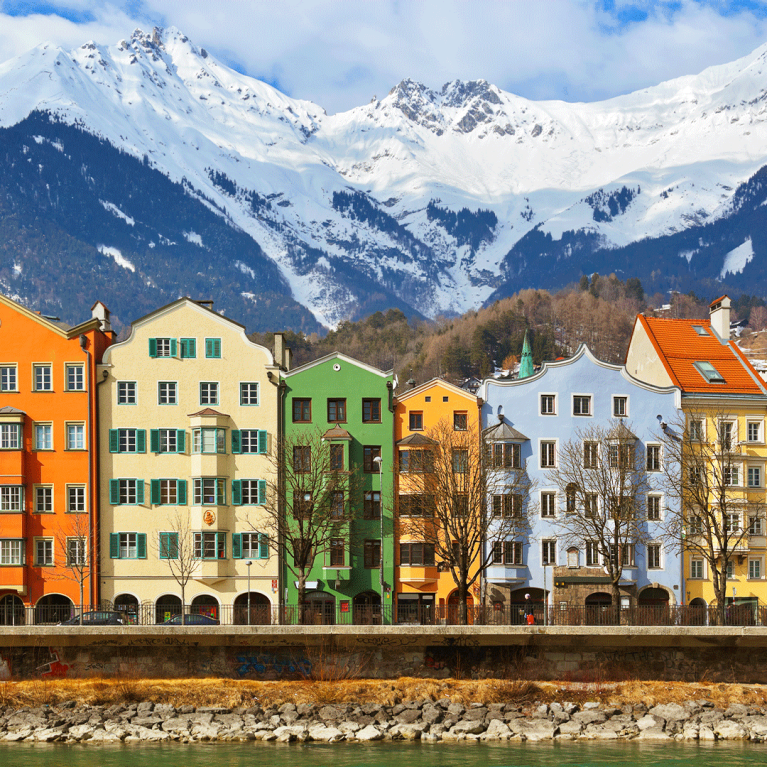 Colourful buildings in Innsbruck with mountains in the background