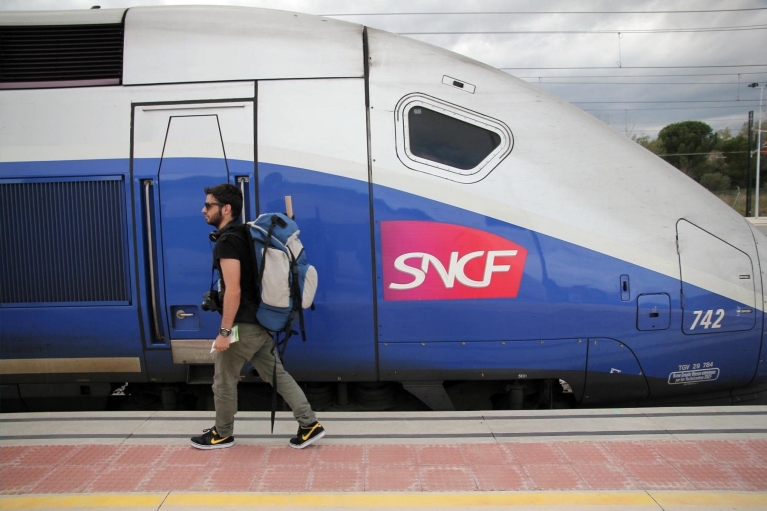 Backpacker walking to tgv train in Figueres